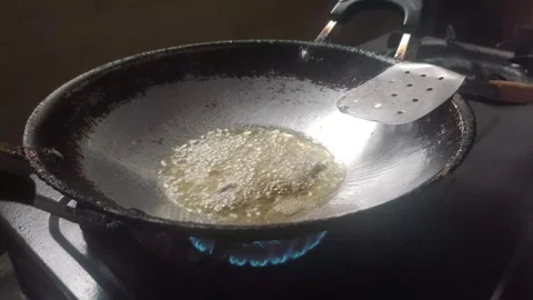 Frying Beef  in Hot Palm Oil Stock Footage 322556445
