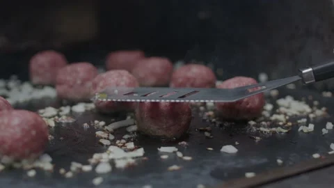 Frying beef meatballs on hot stone grill and smashing it into flat shape Video stock 158811032