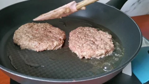 Frying Beef Patties Steak in a Non Stick Pan Stock Footage 231119575