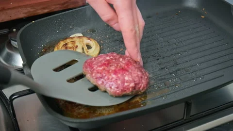 Frying beef steak and burger ingredients on the grill in 4K. Stock Footage 153743085