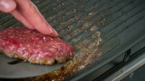 Frying beef steak and burger ingredients on the grill in 4K. Stock Footage 153757656