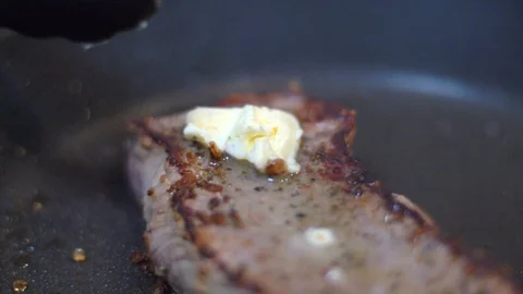 Frying beef steak in a pan Stock Footage 114077181
