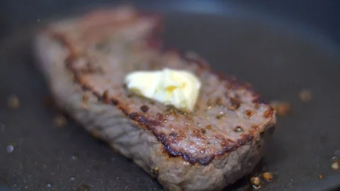 Frying beef steak in a pan Stock Footage 114078902