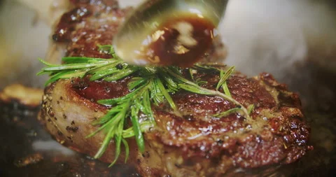 Frying of a beef steak with rosemary and thyme on the pan - close-up 動画素材 88958292