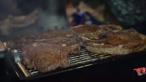 Frying beef steaks on the bone on a grill. Stock-Footage 274926203