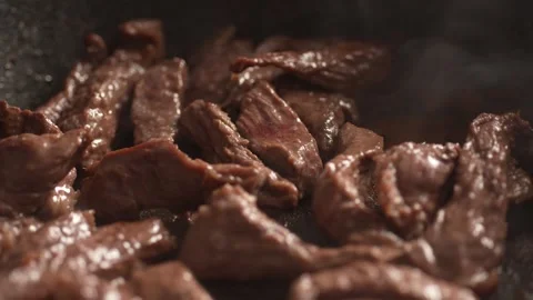 Frying Beef Strips in Pan with steam. Stock Footage 260340659