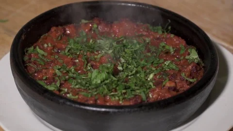 Frying bens in tomato sauce in the pot, slow motion Video stock 73623697