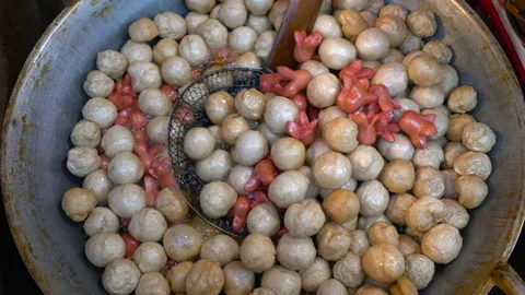 Frying big amount of meat balls and sausages in oil on pan. Thailand Stock Footage 161956180