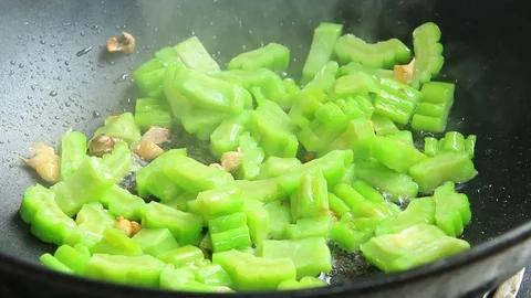 Frying bitter melon in pan, Chiangmai Thailand Stock Footage 115640631