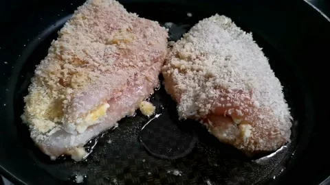 Frying Breaded Chicken Breast with cheese Fillings inside Stock Footage 148402235