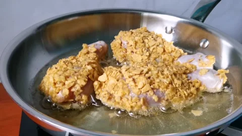 Frying Breaded Chicken Legs with Crushed Nachos Chip Stock Footage 161006115