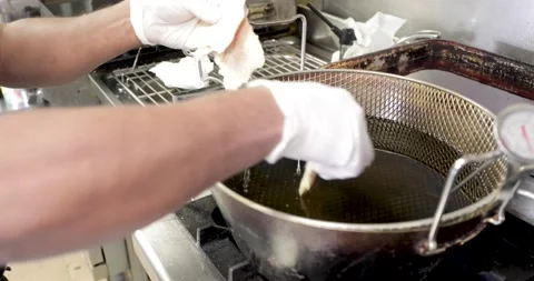 Frying breaded food in a pan in boiling oil Stock Footage 136100947