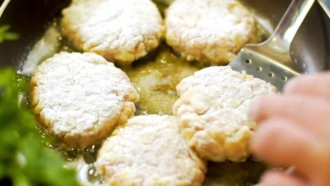 Frying breaded meat cutlets in a pan with oil Stock Footage 333875875
