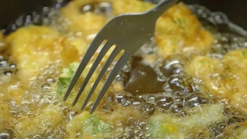 Frying broccoli in batter in boiling oil - Christmas Dinner Video stock 90429050