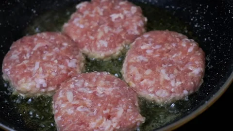 Frying a burger in a pan. barbeque.Frying a burger in a pan. barbeque. Stock Footage 151410645