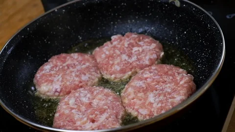Frying a burger in a pan. Grilled. Stock Footage 122287417