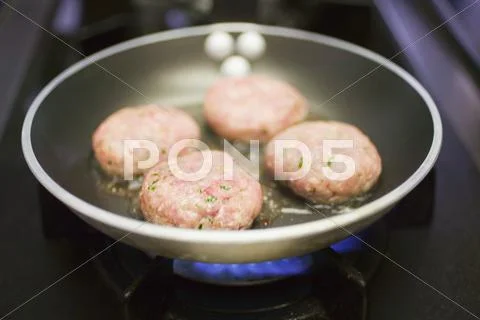 Frying Burgers In A Frying Pan