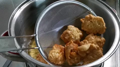 Frying Buttered Garlic Chicken and Strain After Stock Footage 148402214