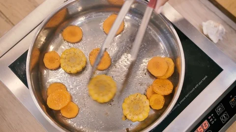 Frying carrots and corn in a pan top view Stock Footage 125921853