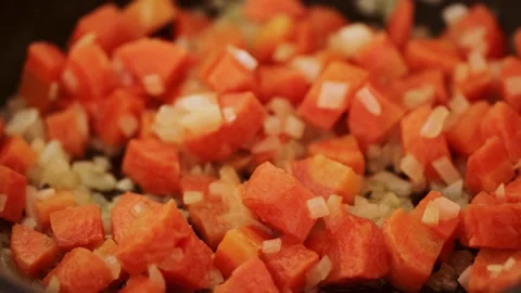 Frying carrots in a pan Stock Footage 133341432