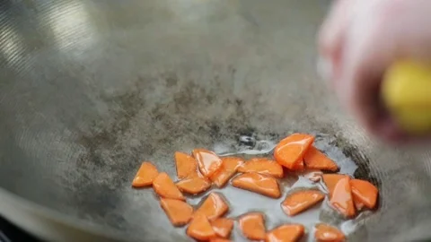 Frying carrots with a spatula Stock Footage