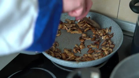 Frying champignon mushrooms on pan Stock Footage 161160349