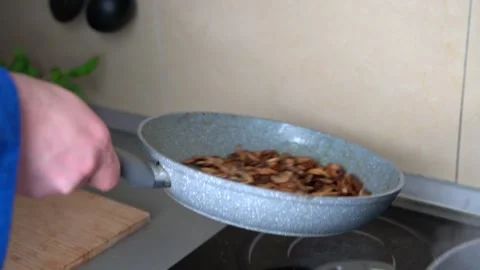 Frying champignon mushrooms on pan Stock Footage 161161764