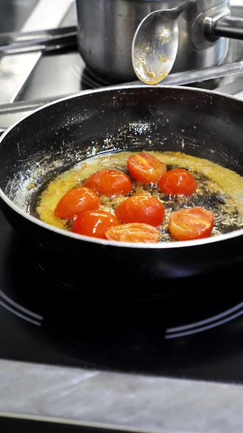 Frying cherry tomatoes in a pan with oil. Stock Footage 342025054