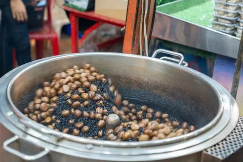 Frying chestnuts in oven roasted. Stock Photos