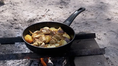 Frying Chicken and Potato on Campfire Stock Footage 293266162