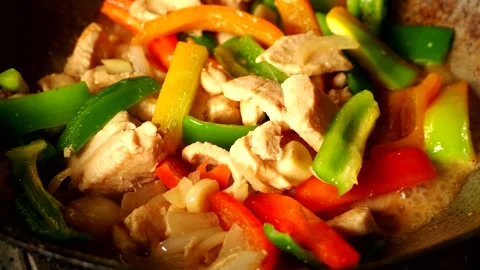Frying chicken breast with bell pepper inpan, in door  Chiangmai  Thailand. Stock Footage 274038153