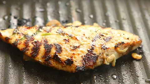 Frying chicken breast in pan, in door  Chiangmai  Thailand Stock Footage 162307044