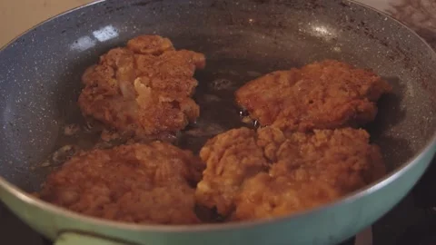 Frying chicken breasts in a pan Stock Footage 132829346