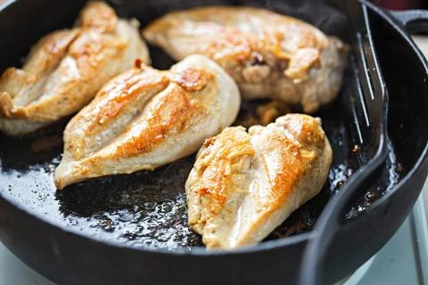 Frying chicken breasts Stock Photos