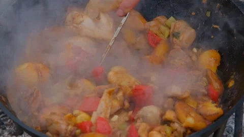 Frying chicken in a cauldron. Chicken meat in a cauldron. Outdoor cooking Stock-Footage 278463322