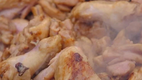 Frying chicken in a cauldron. Chicken meat in a cauldron. Outdoor cooking Stock Footage 278926100