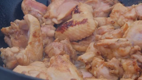 Frying chicken in a cauldron. Chicken meat in a cauldron. Outdoor cooking Video stock 280213899
