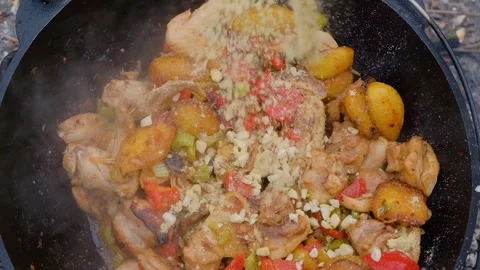 Frying chicken in a cauldron. Chicken meat in a cauldron. Outdoor cooking Stock Footage 284174040