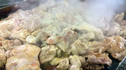 Frying chicken cubes, on a frying pan, at a restaurant kitchen Stock Footage 57245787