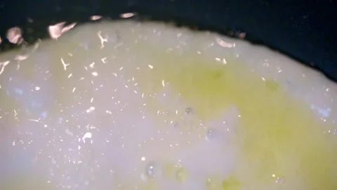Frying chicken egg on frying pan with sizzling olive oil, yolk and white of egg Stock Footage 273364826