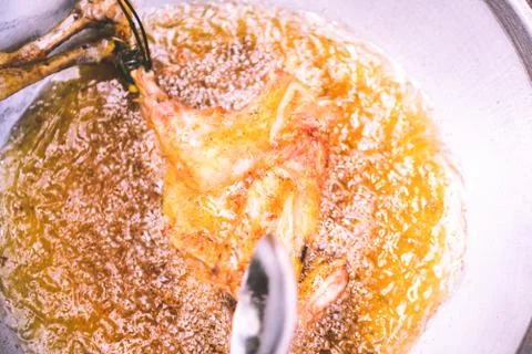 Frying chicken in frying pan with fully oil, cooking concept 스톡 사진