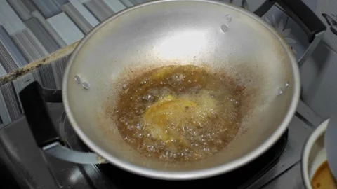 Frying the chicken on a griddle using hot cooking oil raises the foam on to.. Stock Footage 241995732