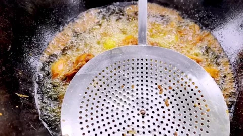 Frying Chicken in Hot Oil During Traditional Cooking Process Stock Footage 339533034