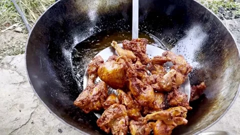 Frying Chicken in Hot Oil During Traditional Cooking Process Stockbeeldmateriaal 339533069