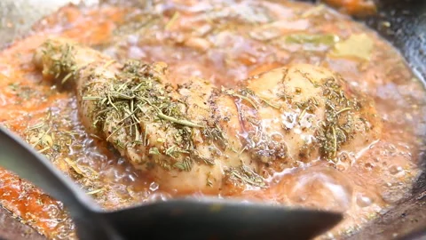 Frying chicken leg with herb  in pan, in door  Chiangmai  Thailand Stock-Footage 152564365