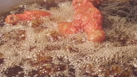 Frying chicken legs in batter in boiling oil 스톡 동영상 274869808