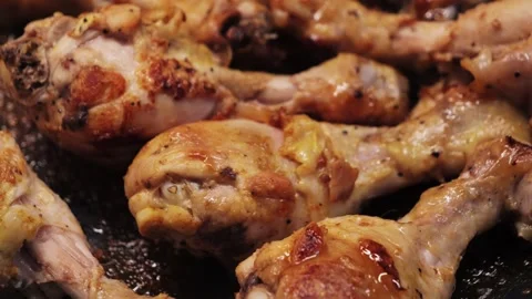 Frying chicken legs in a frying pan. Close up of bbq chicken legs. Stock Footage 323294033