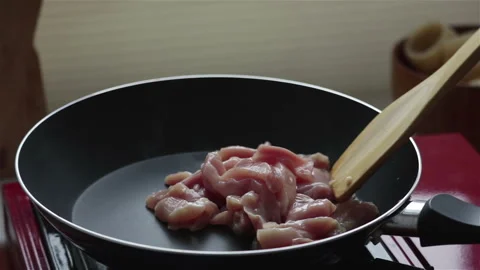 Frying chicken meat in pan close up Stock Footage 249372250