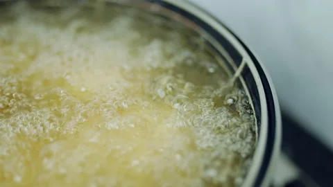 Frying Chicken in a pan full of oil. A pan with a frying basket in 4K. Stock Footage 138282832