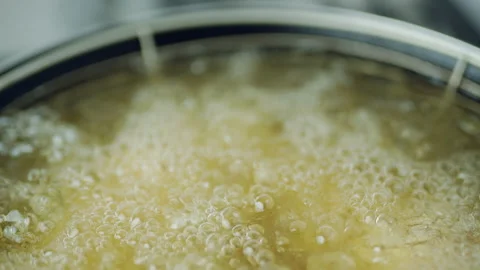 Frying Chicken in a pan full of oil. A pan with a frying basket in 4K. Stock Footage 138283629